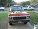 1978 Ford Bronco - Front view of a 1978 Ford Bronco flame decals on its hood, with other vehicles in the background.