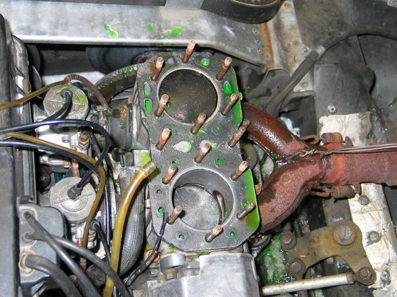 snowmobile engine with two cylinders exposed, green coolant visible