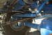 1986 Ford Bronco - Close-up of a vehicle's undercarriage, focusing on the suspension and tire.