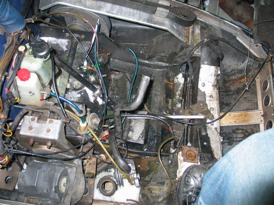 Snowmobile engine compartment with hoses, wires, and mechanical parts
