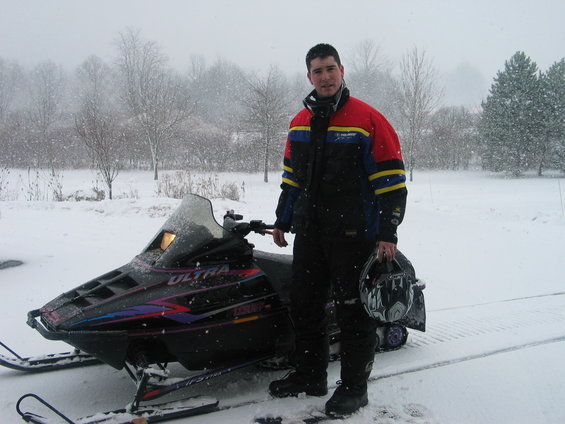 Snowmobile with rider in snowy weather