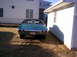 1971 Chevrolet Chevelle - Rear view of a teal 1971 Chevrolet Chevelle parked next to a white building.