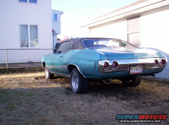 1971 Chevrolet Chevelle coupe, teal paint, black vinyl top, aftermarket wheels, parked in yard