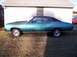 1971 Chevrolet Chevelle - Side view of a blue 1970 Chevrolet Chevelle coupe with a black vinyl top and aftermarket wheels.