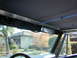 1967 Ford Bronco - soft top mounted to the front winshield. the previous owner installed the ropes that connect to the roll cage, this help to relieve some of…