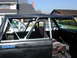 1967 Ford Bronco - Interior view of a black Ford Bronco, showing its roll cage and a sticker for a Ranger specialist company.