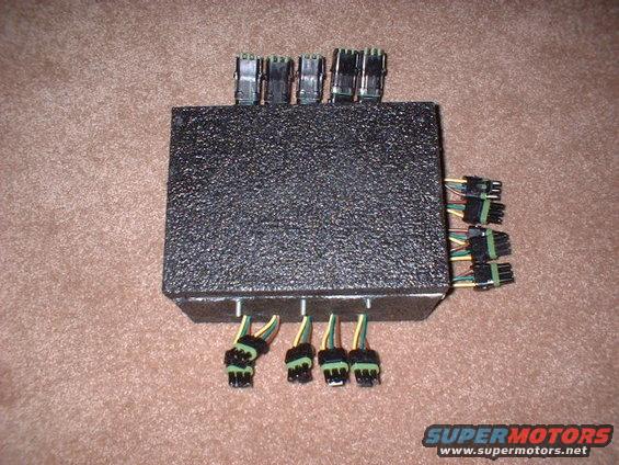 Black electronic control module with multiple wire harnesses