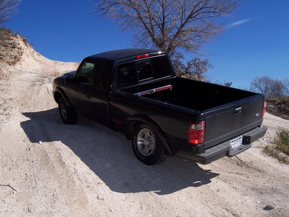 Black 2003 Ford Ranger pickup truck on a dirt road
