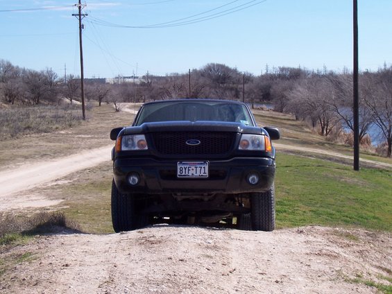 Front view of a black 2003 Ford Ranger on a dirt road