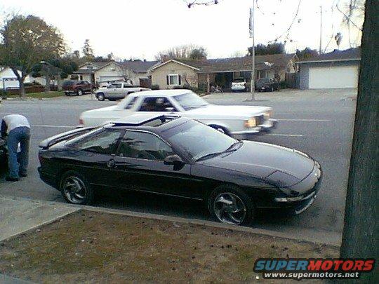 Black 1993 Ford Probe with sunroof, 3q front view