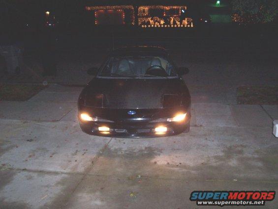 Black 1993 Ford Probe parked in driveway at night