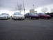 1993 Ford Probe - Four Ford Probe cars are parked in a lot, with a Nissan 300ZX on the far left.