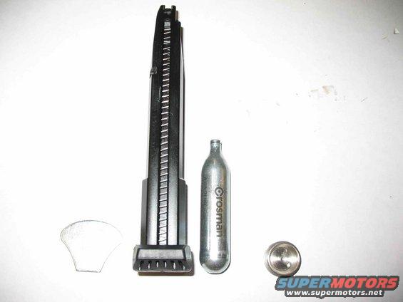 Air gun magazine, Crosman CO2 cartridge, and a metal disc