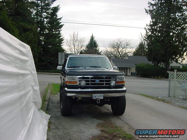 Black Ford Bronco with lifted suspension, front view. License plate visible