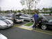 1993 Ford Probe - Several Ford Probes are gathered in a parking lot, with some owners checking under the hoods.
