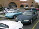 1993 Ford Probe - A dark blue coupe with its trunk open is parked in a lot, with other vehicles visible.