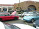 1993 Ford Probe - Two cars parked in a lot, a red Ford Probe and a blue Mazda Miata.