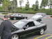 1993 Ford Probe - Two black Ford Probes are parked in a lot, with one car's hood and trunk open.