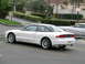 1993 Ford Probe - A white 1993 Ford Probe GT is parked in a lot, seen from the rear three-quarter angle.