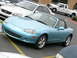 1993 Ford Probe - A light blue convertible sports car is parked in a lot, with other vehicles visible around it.