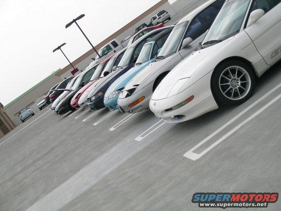 White 1993 Ford Probe in a parking lot, front 3/4 view, showing alloy wheels and 'GT' badging