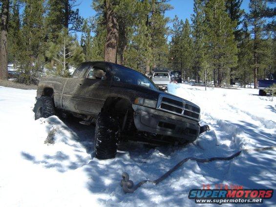 Dodge Ram stuck in snow, other trucks in background