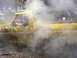 1990 Ford Bronco - A yellow 1978 Ford Bronco navigates a muddy terrain, with steam rising around it.