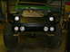 1990 Ford Bronco - Rear view of a modified truck bed with custom lighting and large off-road tires.