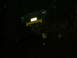 1990 Ford Bronco - A green tractor with a yellow front loader is shown in the dark.