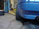 1998 Volkswagen Jetta - Rear view of a blue car in a garage, showing the bumper and tire.