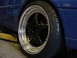 1998 Volkswagen Jetta - A close-up view of a custom wheel and tire on a blue vehicle, possibly undergoing maintenance.