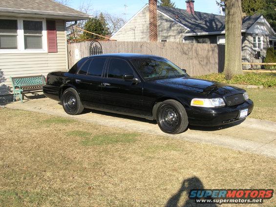 Black sedan with steel wheels parked on a driveway