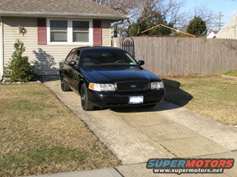 Black 1999 Ford Crown Victoria parked in driveway