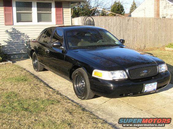 Black 1999 Ford Crown Victoria, 3/4 front view. Black grille and steel wheels