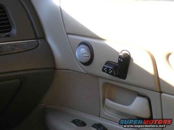 Interior door panel with speaker and power seat controls
