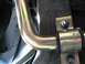 1999 Ford Crown Victoria - Close-up view of a vehicle's suspension system, showing a metal bar and mounting hardware.