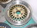 1998 Volkswagen Jetta - A close-up of a gold mesh alloy wheel with a silver outer rim, showing visible text on the barrel.