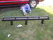 2000 Chevrolet Tahoe - A person works on a red Chevrolet pickup truck, with a new bumper laid out on the grass.