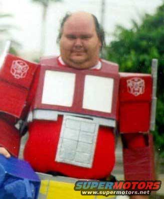 guy wearing a red and silver boxy costume with Autobot logos on shoulders