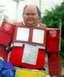 1990 Ford Bronco - A person is dressed in a DIY Optimus Prime costume, complete with the iconic red and blue color scheme and Autobot insignia.