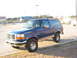 1996 Ford Bronco - A blue 1996 Ford Bronco is shown from a three-quarter front angle in a parking lot.