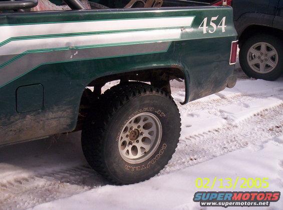 Green 1978 Chevrolet C/K Pickup rear quarter panel with "454" decal, showing a portion of another vehicle in the background
