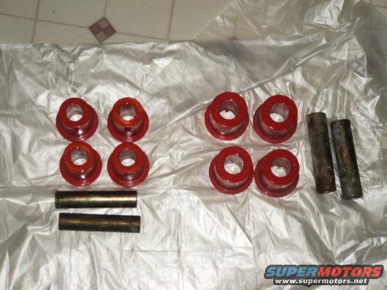 red bushings and metal sleeves laid out on plastic wrap
