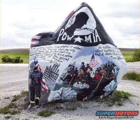 Painted rock with POW-MIA imagery, historical scene, and quotes