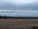 1989 Ford Bronco - Wide landscape scene with mountains in the distance and a field in the foreground.