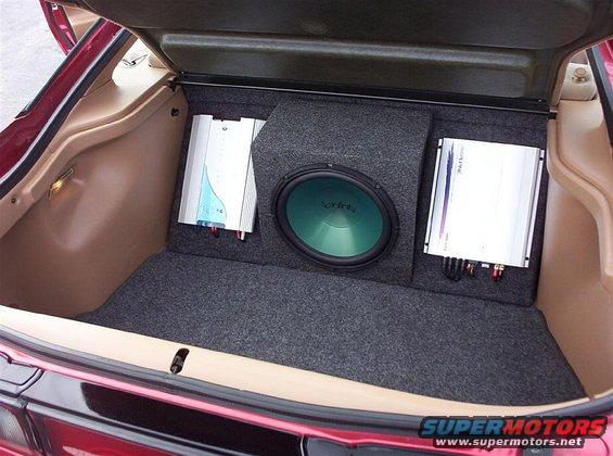 Trunk with green Infinity subwoofer and two amplifiers