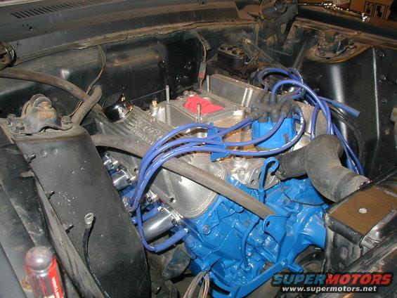 Engine bay with blue engine block and silver valve covers
