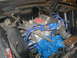 1968 Ford Mustang - Close-up view of a vehicle's engine bay, a blue-painted engine block and silver valve covers.