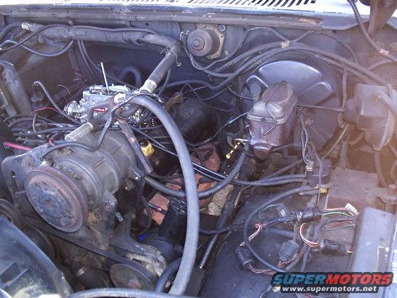 Engine bay with carburetor, brake fluid reservoir, and visible wiring