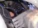 1985 Ford Bronco - Close-up view of engine components covered in oil and grime.